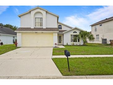 Charming two-story home with a well-maintained lawn and a two-car garage at 3018 Bransbury Ct, Kissimmee, FL 34747