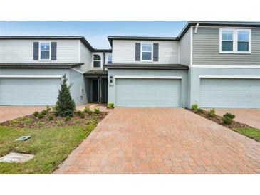 Charming townhome featuring a two-car garage and a well-manicured front yard at 4325 Switchgrass Ln, St Cloud, FL 34772
