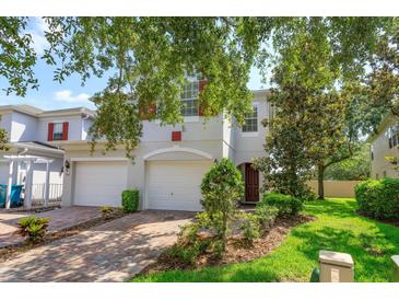 Charming two-story home featuring a two-car garage, brick driveway, and well-manicured landscaping at 5843 Strada Capri Way, Orlando, FL 32835