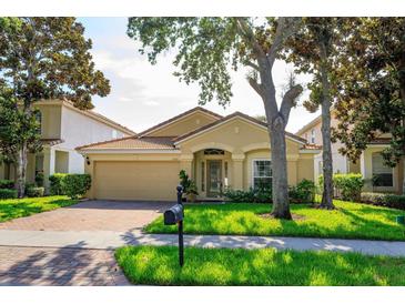 Charming one-story home with a well-manicured lawn, paver driveway, and beautiful landscaping at 6160 Froggatt St, Orlando, FL 32835
