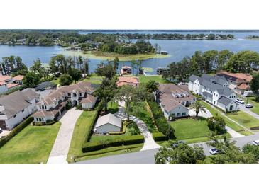 Expansive lakefront homes with manicured lawns and mature trees offer luxurious living at 11018 Lake Butler Blvd, Windermere, FL 34786
