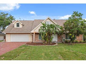 Charming single-Gathering home with a well-manicured lawn, brick accents, and a spacious driveway at 1135 Thunder Trl, Maitland, FL 32751