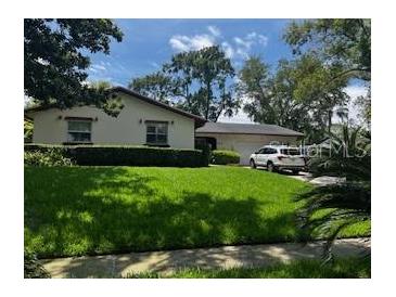 Charming single-story home boasts a well-manicured lawn and a convenient two-car garage at 404 Broadview Ave, Altamonte Springs, FL 32701