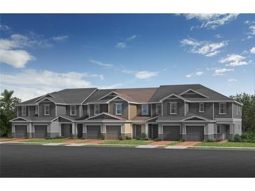 Modern townhome exterior with individual garages, craftsman details, and welcoming curb appeal at 512 Pine Ridge Ct, Lake Wales, FL 33859
