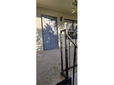 This home boasts a sturdy front door with sidelight windows and classic design at 5930 Village Cir # Ge, Orlando, FL 32822