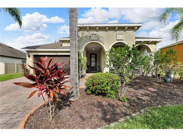 Inviting home with well-maintained landscaping and an arched entryway at 1560 Canopy Pasture Dr, St Cloud, FL 34771