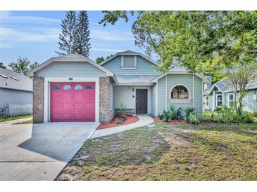 Charming single-story house with a well-maintained lawn, a garage, and mature trees shading the property at 172 Clear Lake Cir, Sanford, FL 32773
