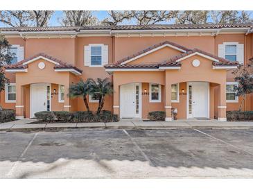 Inviting multi-Gathering exterior with orange facade, arched entryways, and well-maintained landscaping at 2745 Corvette Ln, Kissimmee, FL 34746