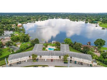 Stunning aerial view showcasing a lakefront building with a pool and serene surroundings at 2893 S Osceola Ave # E6, Orlando, FL 32806
