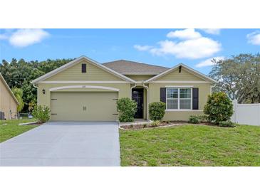 Charming single-story home featuring a well-maintained lawn and a two-car garage at 3235 Utah Dr, Deltona, FL 32738