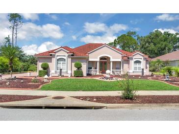Charming home features a red tile roof, manicured lawn, and beautifully landscaped front yard at 736 Timacuan Blvd, Lake Mary, FL 32746