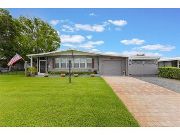 Charming single-story home with a well-manicured lawn and brick driveway at 142 Florence Blvd, Debary, FL 32713