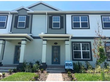 Beautiful townhouse with a well-manicured lawn and inviting brick walkway at 15316 Burgtheater Dr, Winter Garden, FL 34787