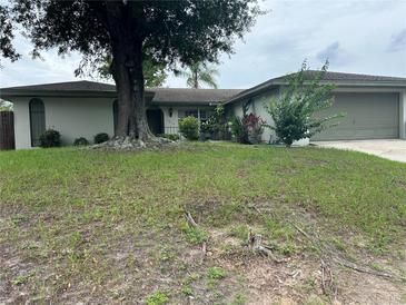 Charming single-story home with mature trees and well-maintained lawn at 1812 Firwood Ct, Orlando, FL 32818