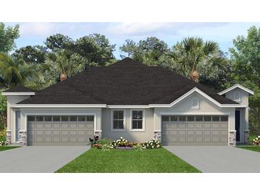 Charming single-story home with a two-car garage, manicured lawn, and tasteful landscaping at 2307 Leela Cir, Tavares, FL 32778