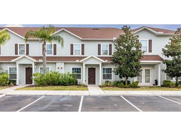 Charming townhouse with well-maintained landscaping and designated parking spaces at 3203 Oyster Ln, Kissimmee, FL 34747