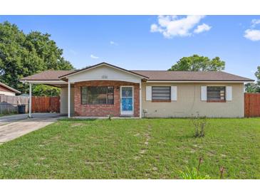 Charming single-story home with a cozy carport, brick accents, and a well-maintained front lawn at 510 Peach Tree Ln, Altamonte Springs, FL 32701