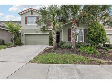 Charming two-story home with well-manicured lawn and two car garage at 7033 Oakwood St, Davenport, FL 33837