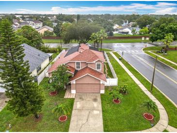 Aerial view of home showcasing the roof, manicured lawn, driveway, and surrounding neighborhood at 12300 Abberton Ct, Orlando, FL 32837