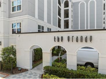 Beautiful building entrance to The Grande, featuring arched entryways and lush landscaping at 206 E South St # 6007, Orlando, FL 32801