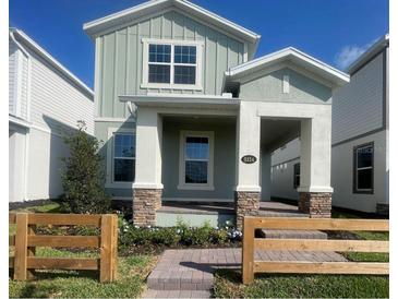 Charming two-story home with a quaint front porch and well-maintained landscaping at 5324 Center Lake Ranch Blvd, St Cloud, FL 34771