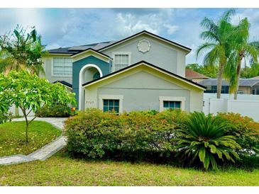 Charming two-story home featuring a landscaped front yard, inviting facade, and well-maintained exterior at 7727 Glynde Hill Dr, Orlando, FL 32835