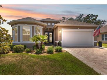 Charming single-story home with manicured landscaping, neutral paint, and an inviting double-door entrance at 9426 Burnam Dr, Weeki Wachee, FL 34613