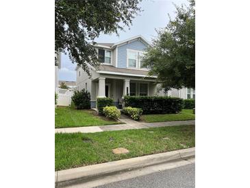 Charming two-story home with a well-manicured lawn and curb appeal at 11097 N Folklore St, Winter Garden, FL 34787
