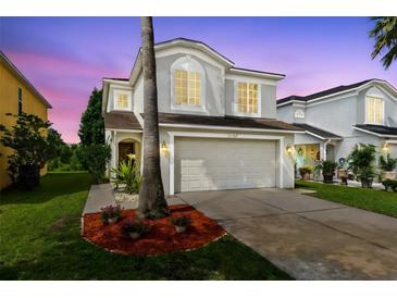 Charming two-story home with a well-maintained lawn and mature landscaping at 15324 Black Lion Way, Winter Garden, FL 34787