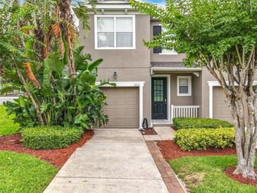 Two-story house with a front yard and a two-car garage at 2005 Compass Flower Way, Ocoee, FL 34761