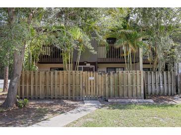Charming townhome with a fenced-in yard and mature trees offering shade and privacy at 2636 Crown Ct, Kissimmee, FL 34741