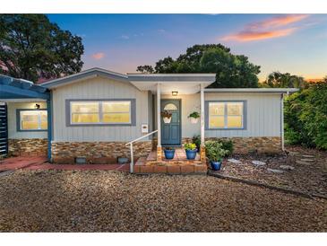Charming single-Gathering home featuring neutral siding, stone accents, and a welcoming front entrance at 3637 Dubsdread Cir, Orlando, FL 32804