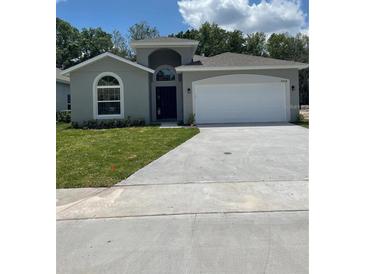 Charming single-story home with a well-maintained lawn and attached two-car garage at 4624 Via Veneto Ct, Kissimmee, FL 34746
