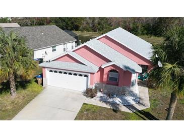 Aerial shot showcasing a two-story home with a well-manicured lawn and a two-car garage in a community at 4700 Prairie Point Blvd, Kissimmee, FL 34746