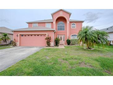 Charming two-story home with landscaped yard and a two car garage in a Gathering-friendly neighborhood at 547 Brighton Ct, Kissimmee, FL 34758