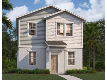 Charming two-story home featuring lap siding, shingle siding, a welcoming front porch, and manicured landscaping at 5626 Stockade Blvd, St Cloud, FL 34771
