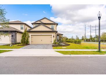 Charming two-story home with a well-manicured lawn, a two-car garage and a cozy, inviting facade at 7951 Haverhill Way, Kissimmee, FL 34747