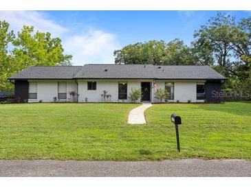 Charming single-story home featuring a well-manicured lawn and a classic design at 897 Shed St, Oviedo, FL 32765
