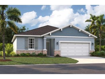 Charming single-story home with a two-car garage, beautiful stonework, and a well-manicured lawn at 1219 Normandy Dr, Haines City, FL 33844