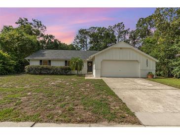 Charming single-story home with a well-maintained lawn and an attached two-car garage at 2003 Bentwood Dr, Winter Park, FL 32792