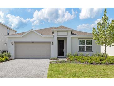 Charming one-story home with a two car garage and welcoming landscaped front yard at 3088 Windswept, Wildwood, FL 34785