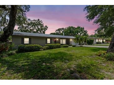 Charming single-story home featuring a well-maintained lawn and mature trees offering plenty of shade and curb appeal at 310 E Gulley Ave, Oakland, FL 34760