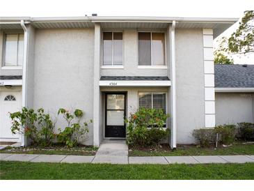 Charming townhouse featuring a well-maintained facade and a cozy entrance, and lush landscaping at 4364 White Pine Ave # 3, Orlando, FL 32811