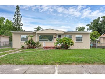 Charming single-story home features a well-maintained lawn and established landscaping at 663 Romano Ave, Orlando, FL 32807