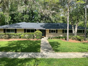 Charming single-story home featuring a stone facade and manicured landscaping for an inviting curb appeal at 955 Gamewell Ave, Maitland, FL 32751