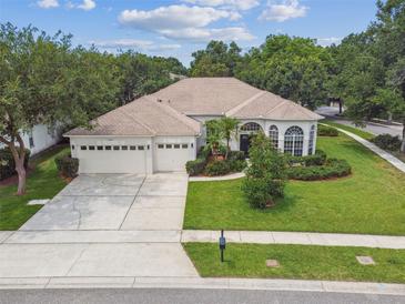 Well-maintained single-story home boasting a three-car garage and mature landscaping at 10080 Cove Lake Dr, Orlando, FL 32836
