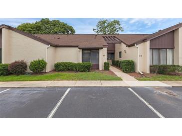 Charming condo featuring a well-manicured lawn, beautiful bushes, and parking spaces ready for you at 101 Grand Plaza Dr # A40, Orange City, FL 32763