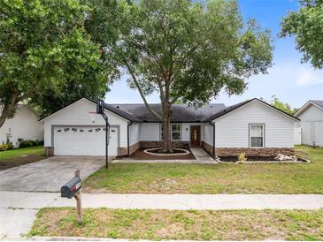 Charming single-story home with a basketball hoop, mature tree, and well-maintained front yard at 1046 Seminole Creek Dr, Oviedo, FL 32765