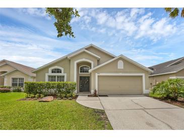 Charming single-Gathering home with a well-maintained lawn, mature shrubs, and a two-car garage at 13826 Mirror Lake Dr, Orlando, FL 32828