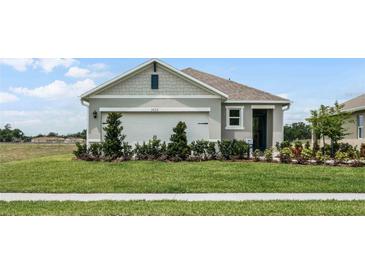 Charming single-Gathering home featuring a well-manicured lawn and a two-car garage at 1666 Badger Creek Rd, Kissimmee, FL 34744